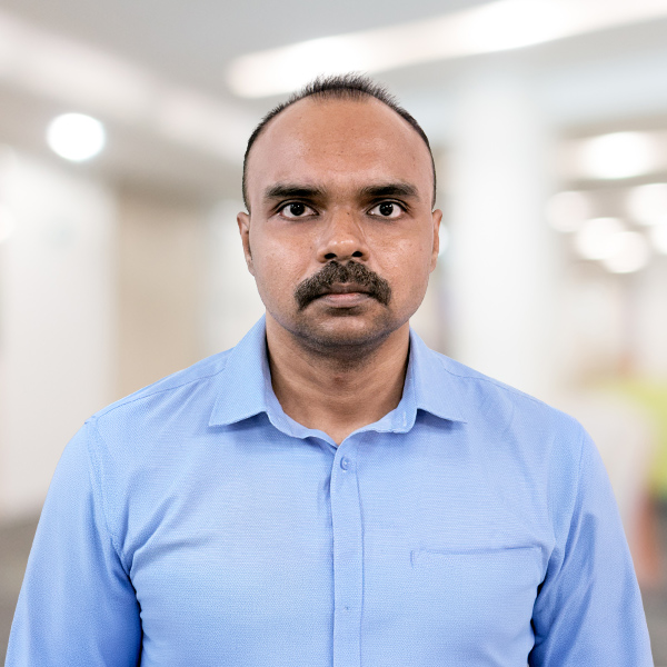 Sumantra-Mukherjee - Datamatics Business Solutions - Datamatics Business Solutions Man wearing a light blue dress shirt, facing the camera in a bright indoor space, neutral expression.